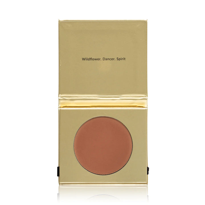 Compact blush in a gold case on a white background