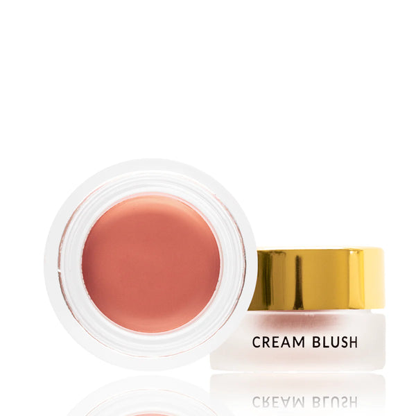 Cream blush with a gold cap on a white background