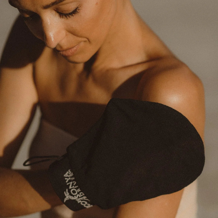 Eco Tan Extreme Exfoliant Glove with woman using it