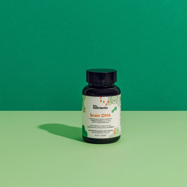 Bottle of brain DHA supplement on a green background