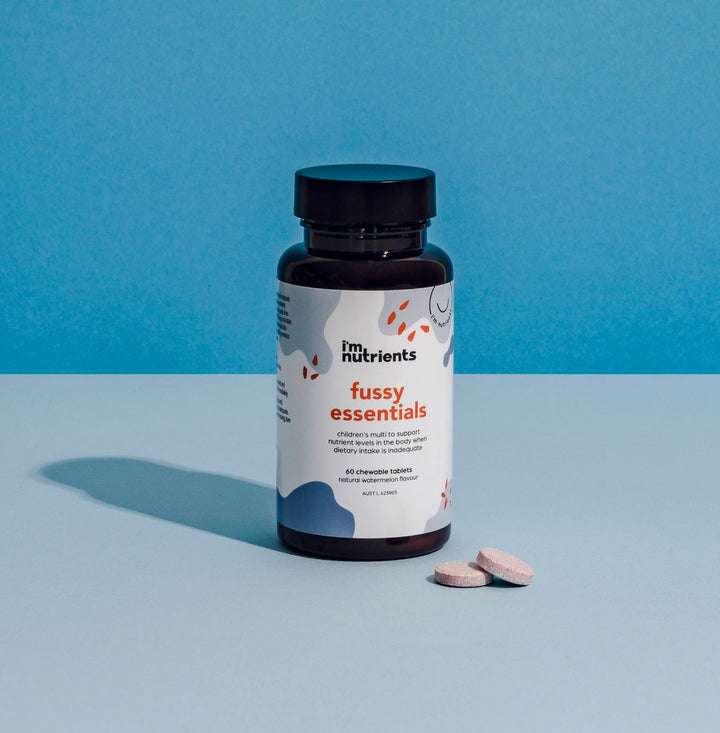 Bottle of 'fussy essentials' supplements on a blue background