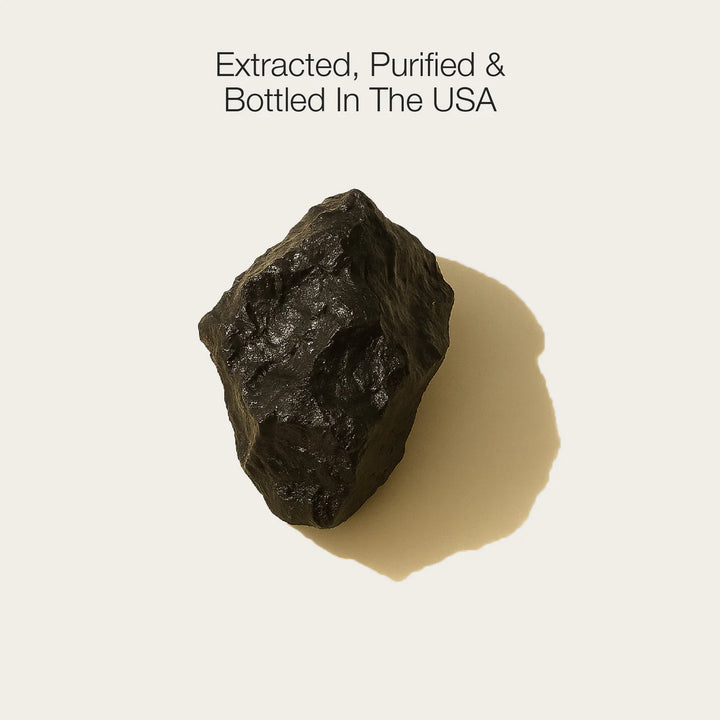 Raw black stone on a beige background with text 'Extracted, Purified & Bottled In The USA'.