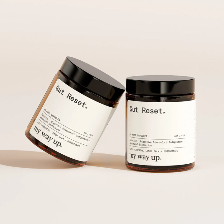 Two jars labeled 'Gut Reset' by 'my way up' on a beige background