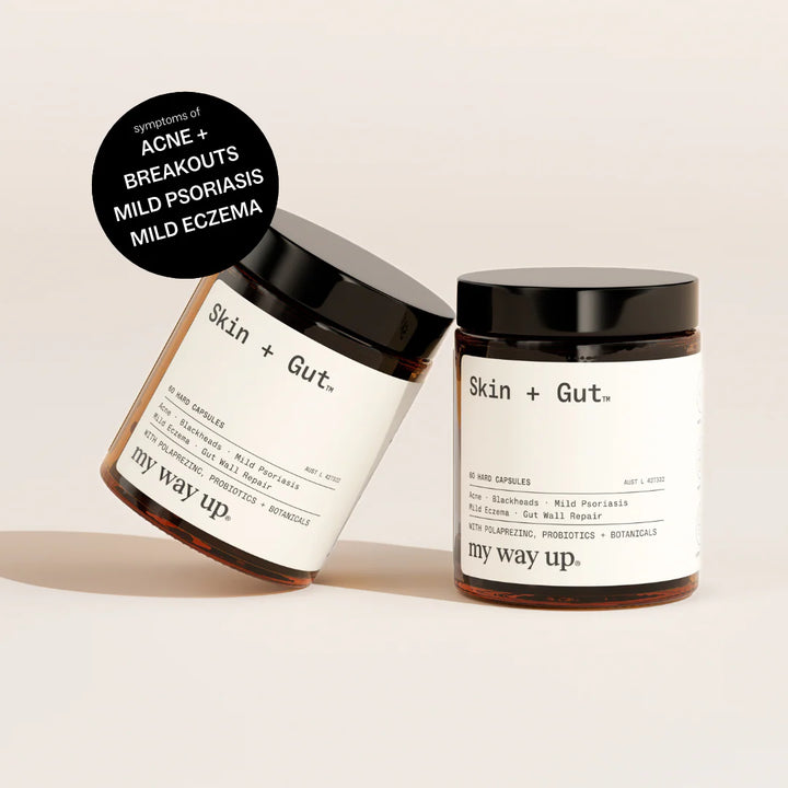 Two jars of 'Skin + Gut' products on a beige background